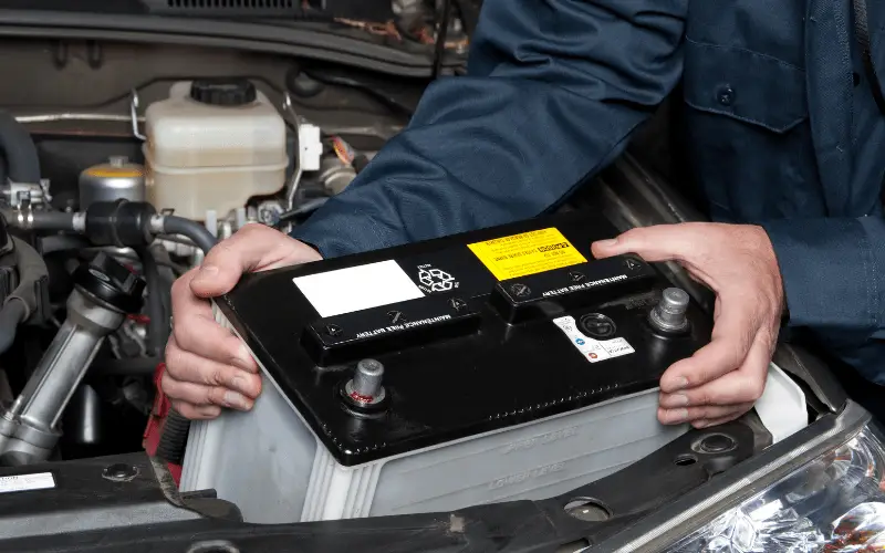 worker checking a car battery